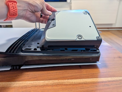 Firstly, mount the drive on one side, then press it down on the other.